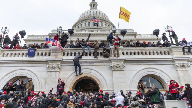Protesters seen all over Capitol building where pro-Trump supporters riot and breached the Capitol in Washington, DC on January 6, 2021. Rioters broke windows and breached the Capitol building in an attempt to overthrow the results of the 2020 election. Police used buttons and tear gas grenades to eventually disperse the crowd. Rioters used metal bars and tear gas as well against the police.