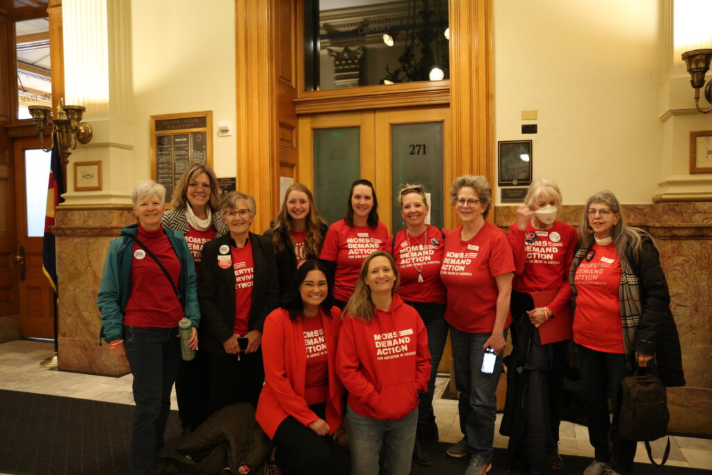 Moms Demand Action volunteers pose for a photo in the Colorado State Capitol