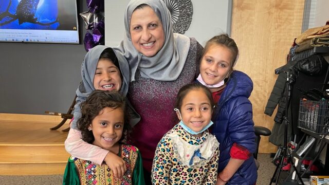 Janan Najeeb poses for a photo with children