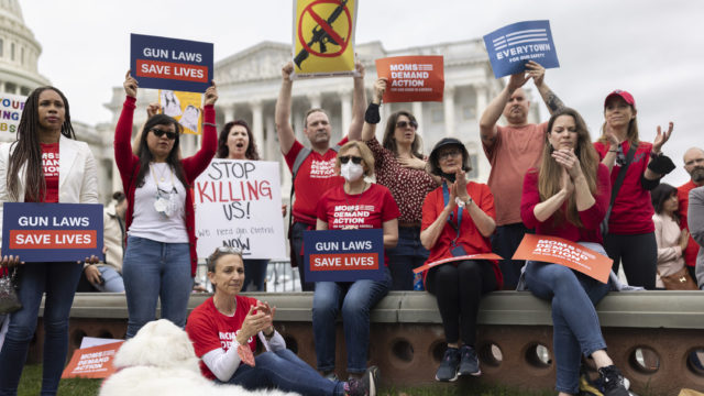 A group gathers in Washington, DC at a rally for stronger gun laws after the Uvalde, Texas mass shooting in May 2022