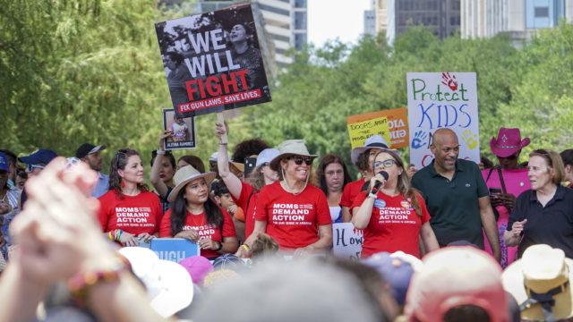 Moms Demand Action volunteers gathered outside the NRA Convention
