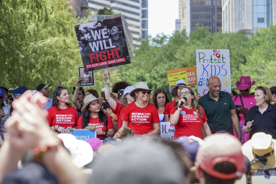 Moms Demand Action volunteers gathered outside the NRA Convention