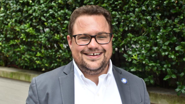 Deputy Executive Director of the National Center for Trans Equality, Rodrigo Heng-Lehtinen smiles outsidie