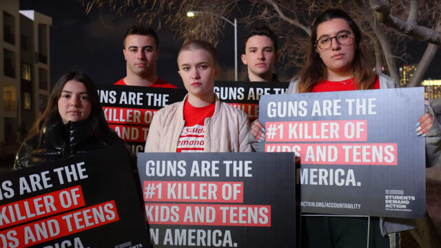 Students Demand Action volunteers holding signs that say “Guns are the #1 killer of kids and teens in America.
