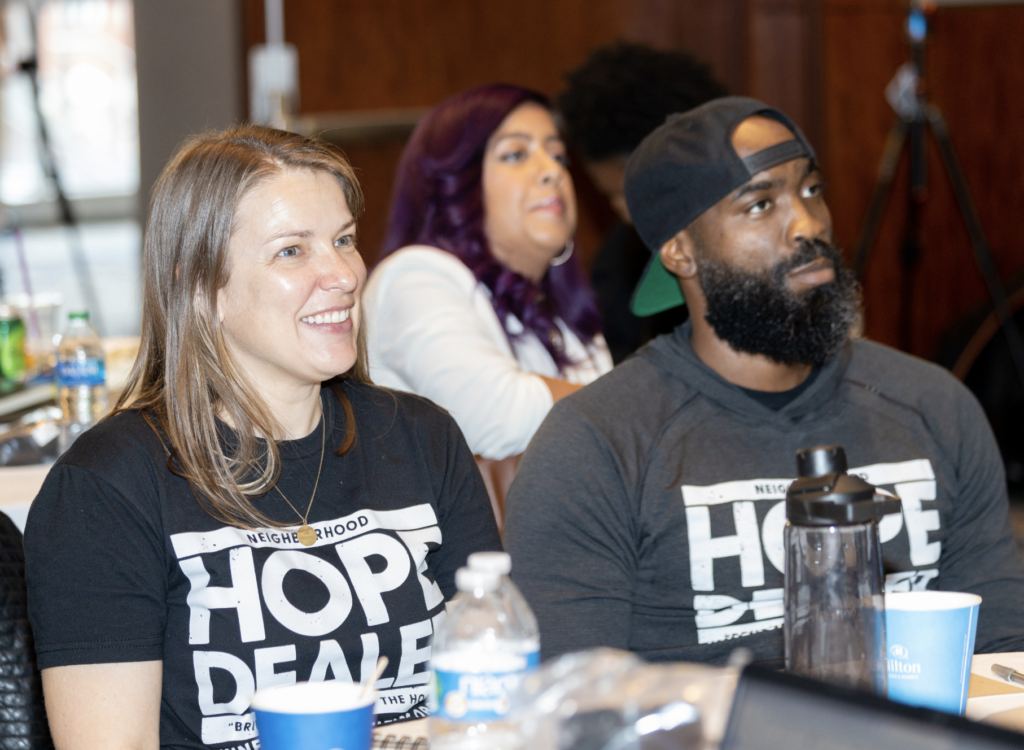 Two members of Neighborhood HOPE Dealer look on at the Community Safety Fund convening