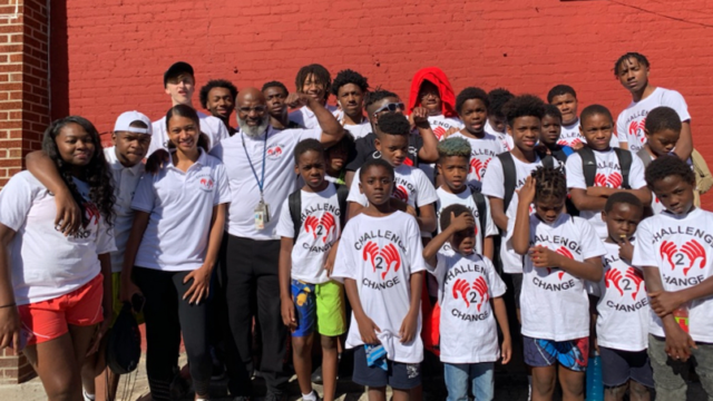 Terry ‘Uncle T’ Williams of Challenge 2 Change poses for a group photo with about 20 young people
