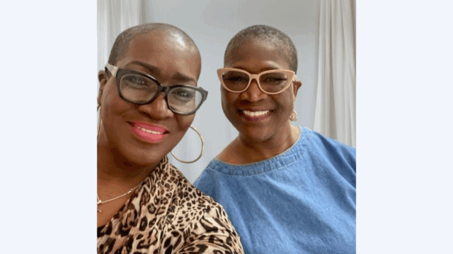 Sharon Robinson and Cynthia Duhart take a selfie together. Both wear glasses and gold jewelry.